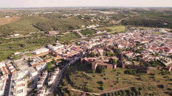 Medieval fortified walled city of Silves, Algarve.  Aerial view of the landmark Castle. alt