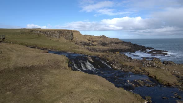 Waterfall and headland at Dunseverick Castle, Co Antrim, Northern Ireland alt