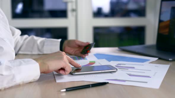 Young Caucasian Hands Buying Goods from the Internet on His Smartphone with His Credit Card alt
