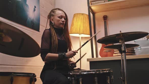 Female Drummer With Dreadlocks Playing Drums alt