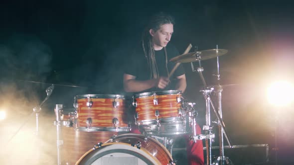 Male Drummer Is Playing the Drums During the Concert alt