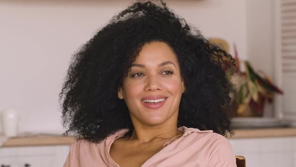 Cute African American Woman Studying Online or Working Remotely Using Laptop Tired and Relaxing alt