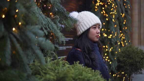 Portrait of Asian Woman in Standing Outside Street Decorated with Garlands