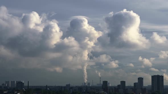 Steam From the Cooling Towers of a Power Plant Located Outside the City Rises Up, Forming a Large