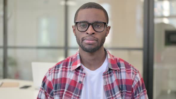 Portrait of Serious African Man Looking at the Camera alt