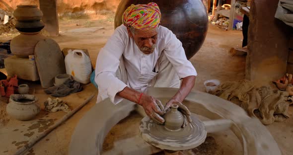 Skilled Professional Potter Throwing the Potter's Wheel and Shaping Traditional Ceramic Vessel and alt