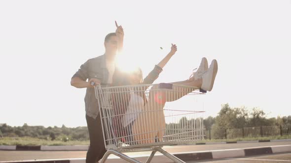 Young Friends Having Fun on Shopping Trolleys alt