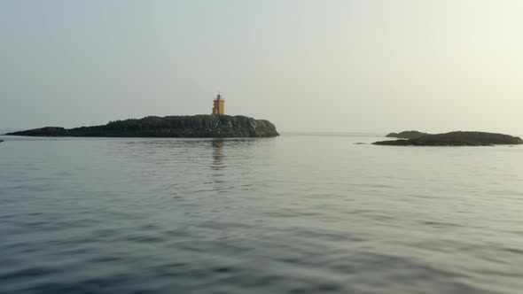 Flying Towards Orange Lighthouse Near Flatey Island, Iceland. Aerial Drone alt
