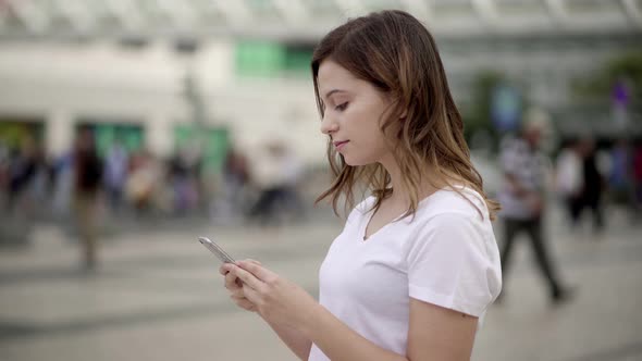 Beautiful Young Woman Using Smartphone on Street alt