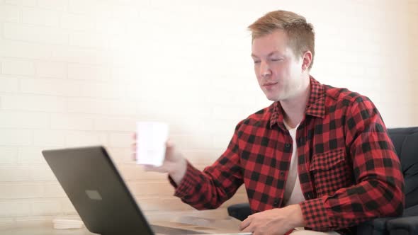 Young Happy Hipster Man Drinking Coffee While Thinking At The Coffee Shop alt