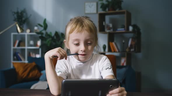 Curious Cute Preschool Kid Girl Using Digital Tablet Technology Device. alt