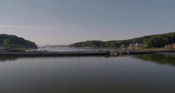 Flying Over Small Bridge and Towards Boats Docked at Huntington Bay Long Island alt