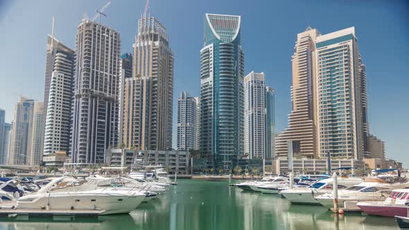 Panoramic View with Modern Skyscrapers and Water Pier with Yachts of Dubai Marina Timelapse United alt