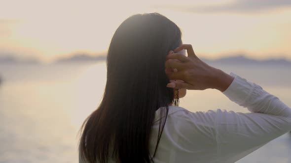 A Portrait of a Beautiful Asian Woman Against Coming Sunset alt