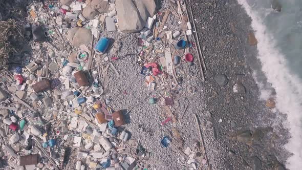 Environmental issues shown by beach covered in plastic and rubbish in Hong Kong. Static aerial drone alt