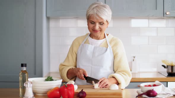 Happy Woman Chopping Champignon on Kitchen