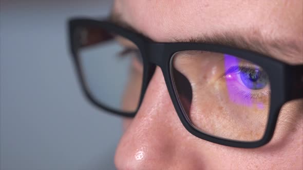 Close Up Shot of a Man's Eyes with Eyeglasses Looking at a Monitor alt