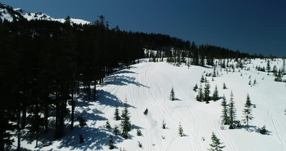 Pro Snowmobiler Rides Up Snowy Mountain Slope At Rapid Fast High Speed alt