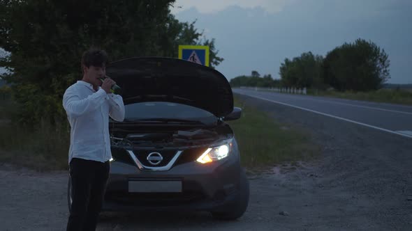 View of a Man That Talks on the Phone and Drinks Beer alt