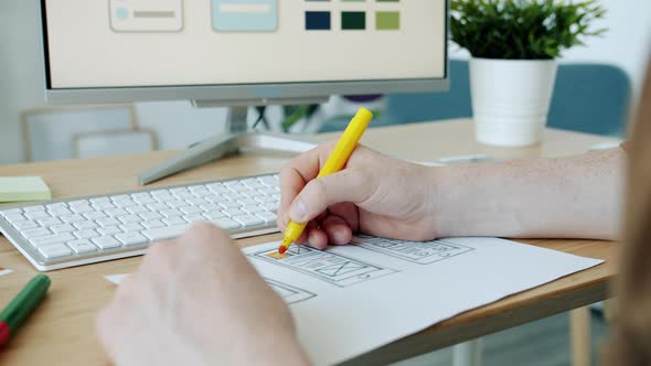 Closeup of Male Hand Coloring Pictures of Smartphone Screen Developing App Interface Design in alt