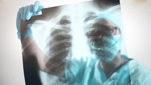 Doctor holding and analyzing an x-ray of some lungs