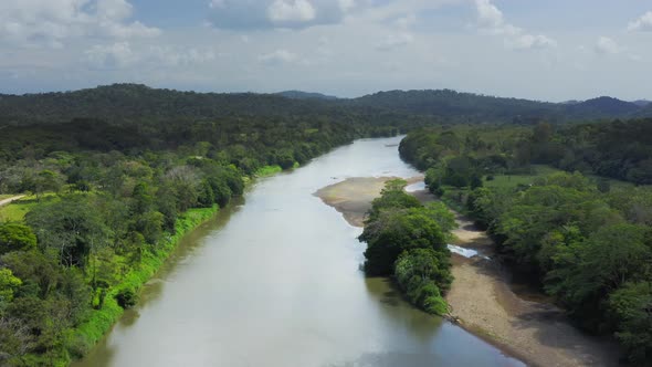 Aerial Drone View of Rainforest River and Mountains Scenery in Costa Rica at Boca Tapada, San Carlos alt