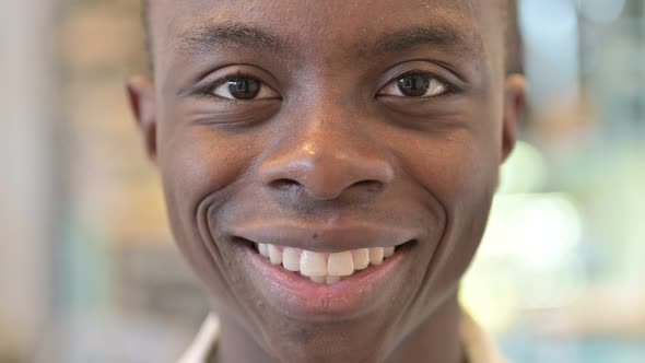 Close up of Smiling African Man Face alt