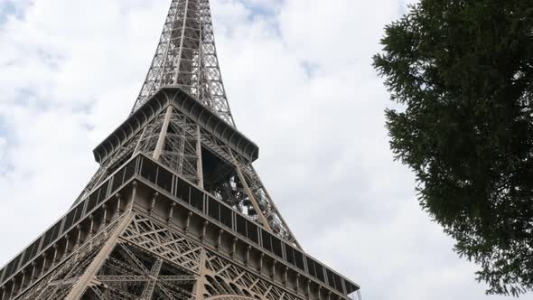 Famous French monument Eiffel towel slow tilt against sun 4K 3840X2160 30fps UltraHD footage - Tilti alt