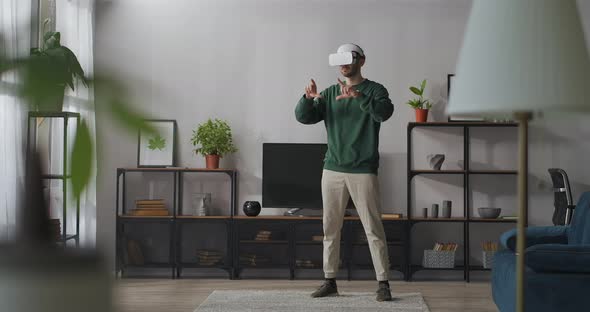 Modern Technology of Virtual Reality for Home Use Man Is Wearing Hmd Display for Connecting Internet alt