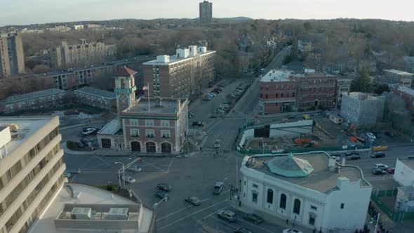 Aerial Drone Shot Flying Over Intersection and Old Fire House with Tower