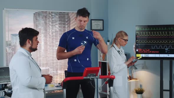 Strong Sportsman Standing on Racetrack and Taking on His Face Mask for Cardio Respiratory Test alt