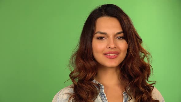 A Young Beautiful Caucasian Woman Smiles at the Camera  Closeup  Green Screen Background