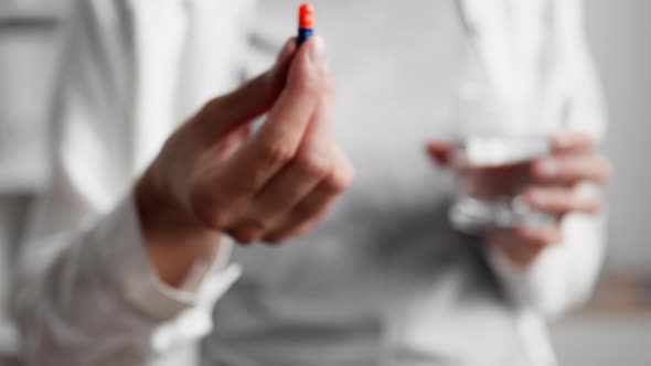 The Hand Holds Out A Pill Capsule Close Up Of A Bright Capsule In The Patient's Hand Treatment Pills alt