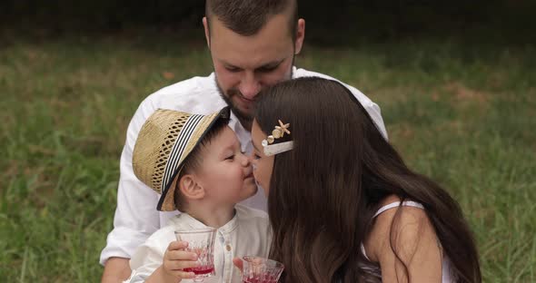 Family at Picnic Kissing and Smiling.