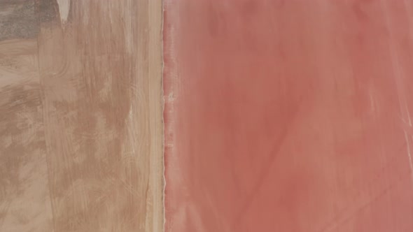 Aerial Birds Eye Overhead Top Down Descending View of Pastel Colour Water Surface of Pink Lakes alt