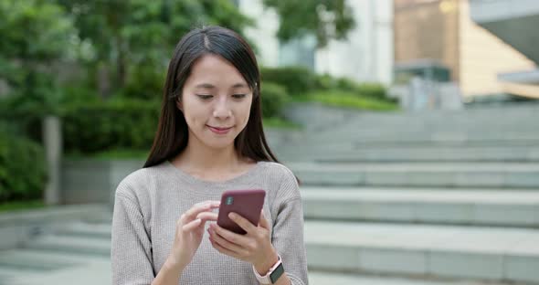 Woman use of smart phone in city alt
