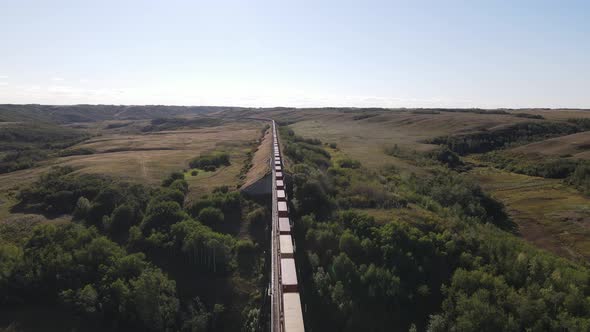 Drone footage of Battle River Trestle Bridge in Alberta. Freight rain traveling through alt
