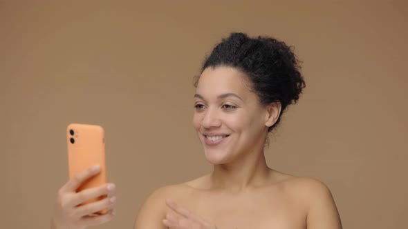 Beauty Portrait of Young African American Woman Talks on a Video Call Using a Smartphone alt