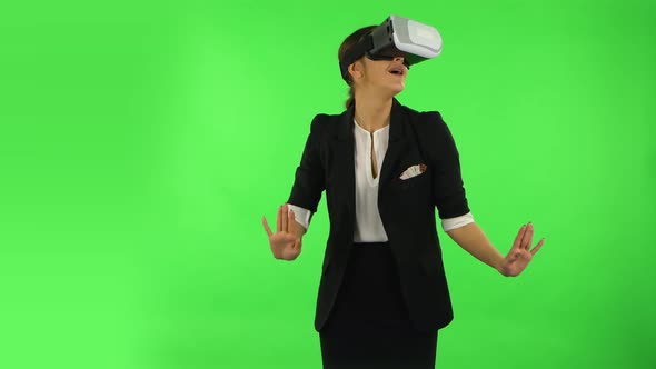 Happy Young Woman with Virtual Reality Headset or 3d Glasses. Green Screen alt