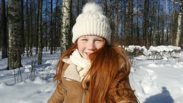 Happy Teen Girl Spinning In Winter Park. POV. Redhead Teenage Girl, Child Having Fun On Winter Walk