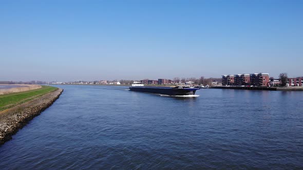 Large Cargo Vessel Sailing Downstream On River Noord In South Holland, Netherlands. - Aerial Shot alt