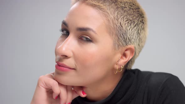 Blonde with Short Haircut in Studio Poses for Camera on Grey Ideal Skin alt