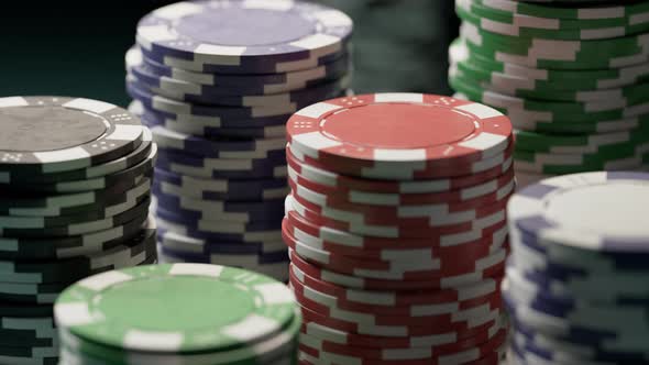 Casino chips or tokens in stacks on a green gaming table. Las Vegas gambling. alt