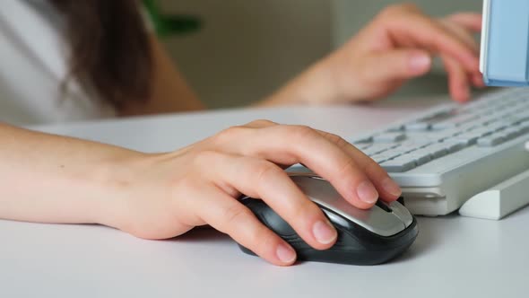 A Woman Works at the Computer Hands Closeup alt