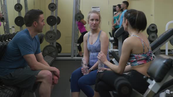 Group of people talking together at gym