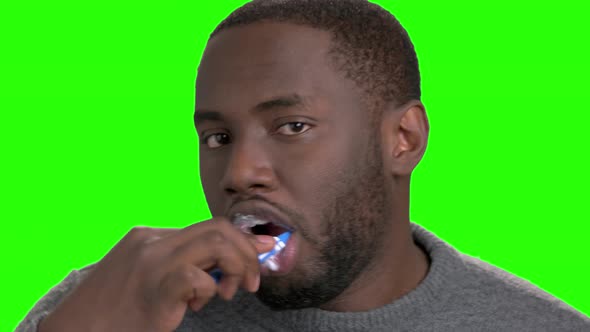 African American Man Brushing His Teeth. alt
