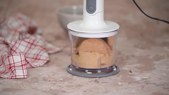 Grinding cookies in a blender. Making a dessert from shortbread cookies.