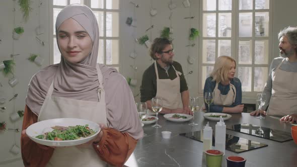 Young Muslim Woman With Dish At Cooking Class alt