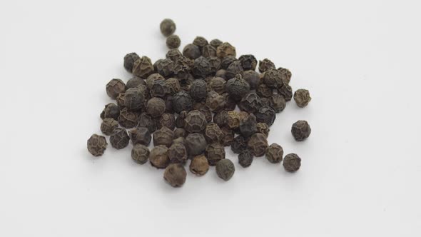 Black Pepper Rotation. Peas with Spices. Macro on White Background alt