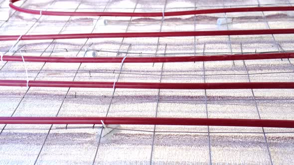 Underfloor heating pipes on insulating material - construction work in the house, preparation for po alt